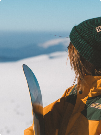 snowboard girl looking at a mountain